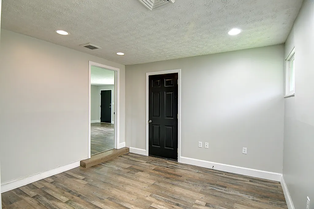 Finished Kettering converted garage after renovation — recessed lighting, fresh drywall, new luxury vinyl plank flooring, clean bonus room