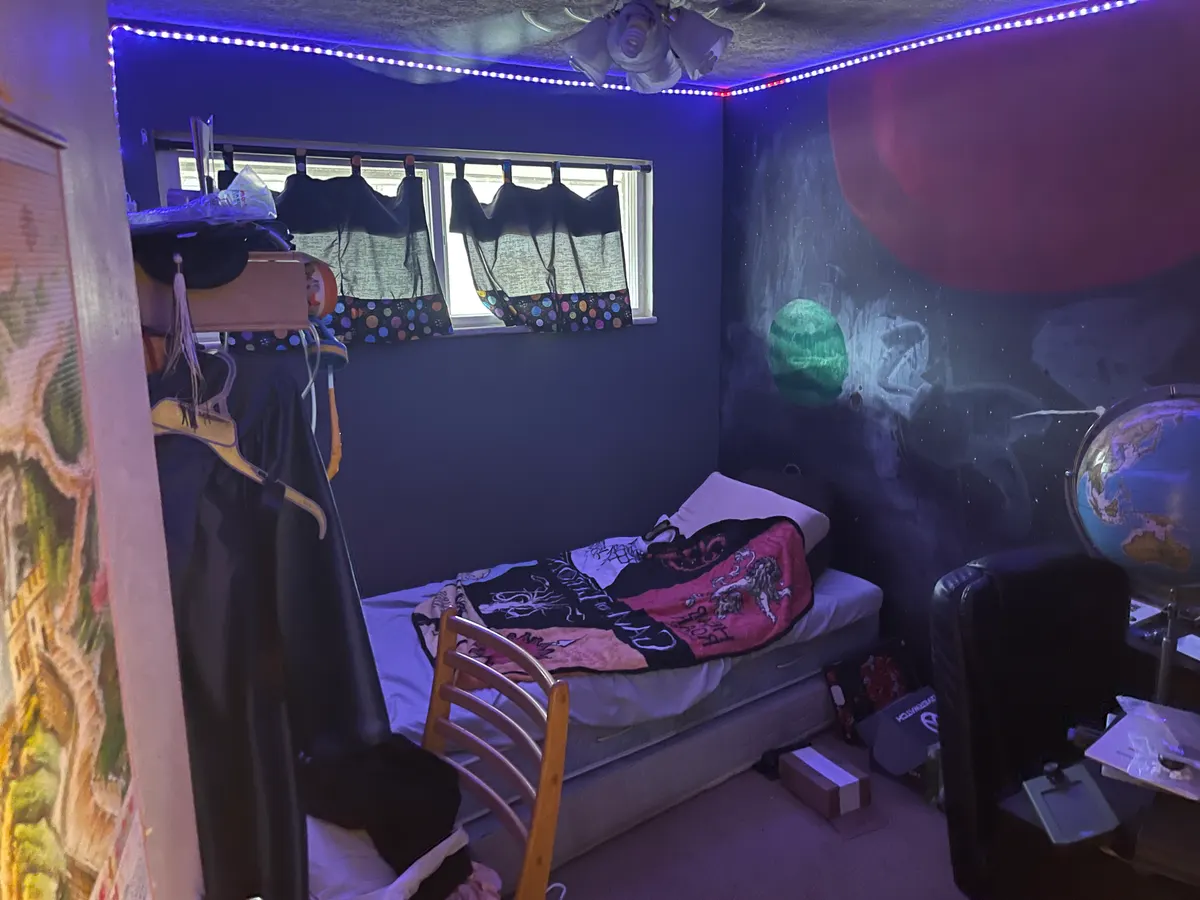 Kettering bedroom before sale — purple walls, LED ceiling lights, cluttered teen bedroom