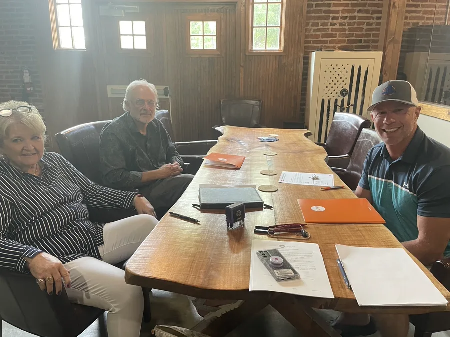 Retired couple at closing table after cash home sale in Dayton OH