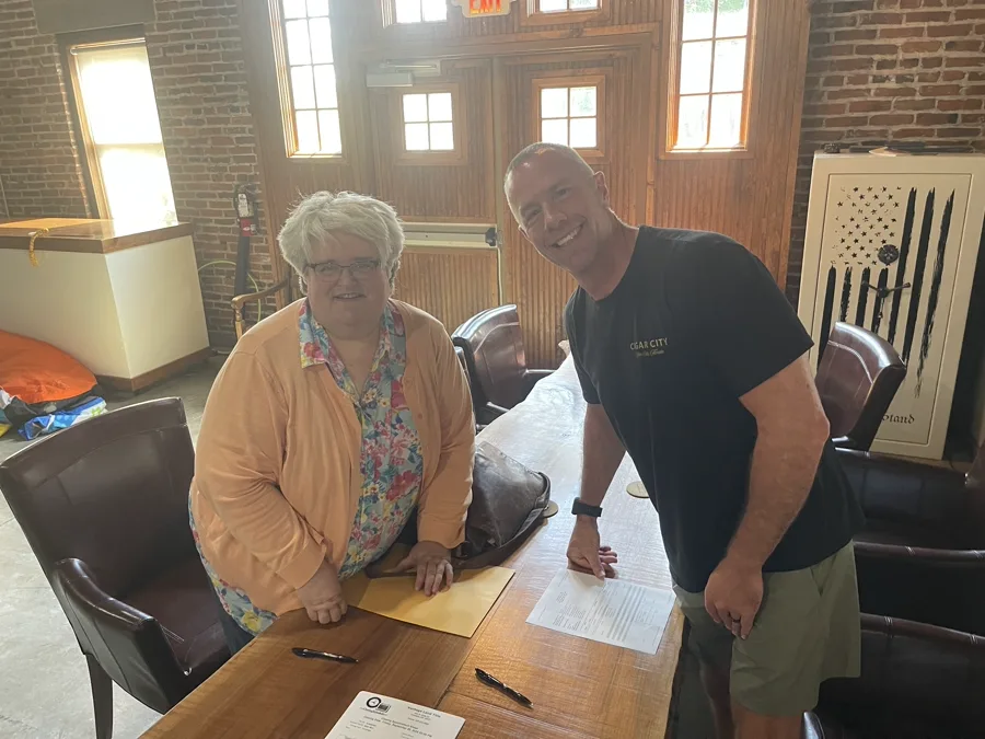 Seller and Mike Wall standing at closing table — Dayton Ohio