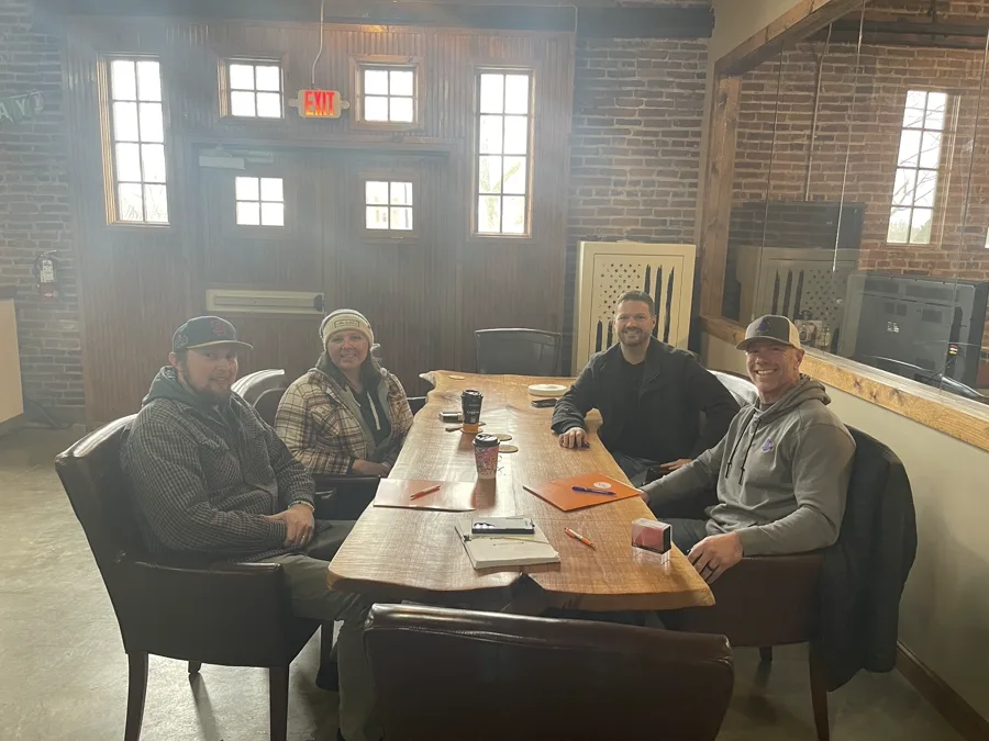 Four people at closing table — EZ Sell Homebuyers cash purchase Dayton